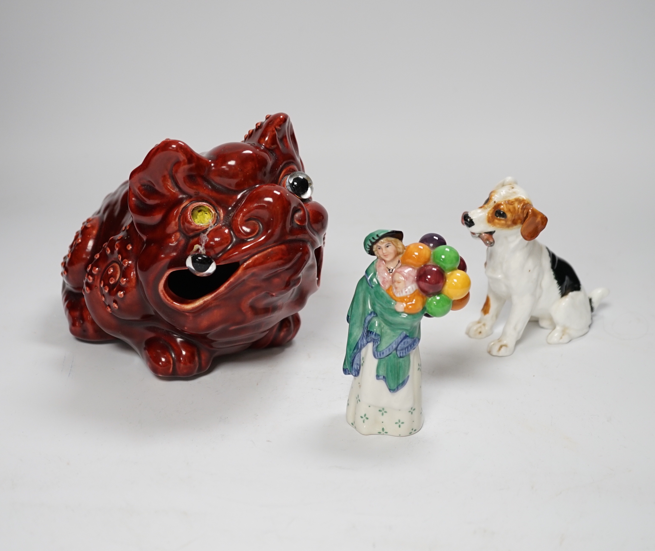 A Burmantofts style grotesque toad spoon warmer, a Royal Doulton dog ornament and The Balloon Seller, toad 18cm long